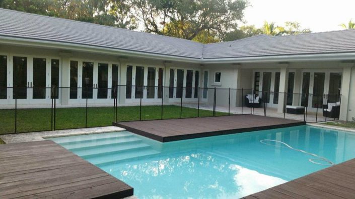 Wraparound impact doors on a pool courtyard